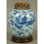 A CHINESE BLUE AND WHITE JAR, the baluster body painted with phoenix amidst stylised clouds, later