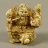 A JAPANESE IVORY NETSUKE, MEIJI PERIOD, carved as a noh player wearing Shikami mask representing a