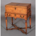 A QUEEN ANNE WALNUT BOX ON STAND, the hinged lid cushion moulded and butterfly veneered within