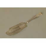A GEORGE III SILVER FIDDLE PATTERN FISH SLICE with pierced and part fluted blade, engraved with a