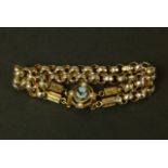 A BRACELET IN 9CT GOLD, the twin strands of Victorian faceted belcher and engraved hexagonal