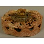 A CHINESE CARVED SOAPSTONE INKWELL, the shallow cylindrical body pierced and carved with foxes,