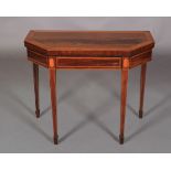 A GEORGE III INLAID MAHOGANY CARD TABLE, the chamfered oblong top with figured panel within broad