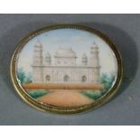 An early 20th century brooch in silver set with a miniature landscape of The Maghal Gardens of Agra,