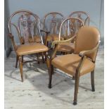 A set of five reproduction Windsor style dining chairs with arched backs, pierced splats carved with