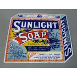 A reproduction Sunlight Soap enamel sign