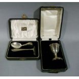 A child's silver spoon and pusher in fitted case, Birmingham 1927, together with a silver egg cup in