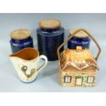 Three Portmeiron pottery jars with wooden covers, together with a Torquay ware style pinched jug
