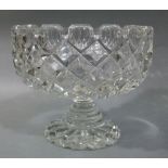 A large cut pedestal fruit bowl with castellated rim and stepped pedestal on a scalloped foot