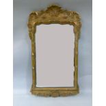 An 18th century style gilt gesso wall mirror moulded with shells, acanthus leaf and rocaille,