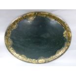 A Victorian black japanned oval tin tray decorated with a border of gilt foliate scrolls, 76cm wide