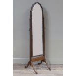A walnut cheval mirror in Queen Anne style, the plate within a cushion moulded frame, pair of