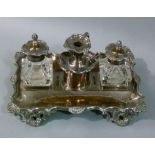 A Victorian plated on copper desk standish fitted with two glass inkwells and chamberstick, the