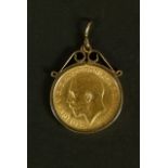 A George V half sovereign 1912 channel set within a 9ct gold scroll topped pendant mount, total
