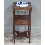 A George III mahogany three tier washstand, the upper tier with replaced pottery liner, the middle