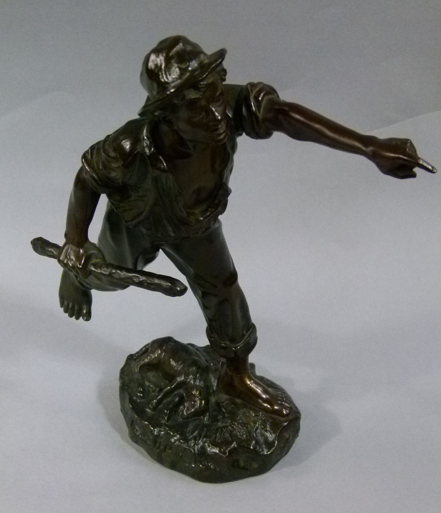 A 19th century bronze figure of a shepherd, a cudgel in his hand and a dead sheep at his feet,