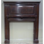 A mahogany fire surround with Greek key moulded concave cornice, the frieze guilloche and foliate
