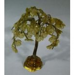 A glass and gilt metal weeping tree ornament on sculpted glass base