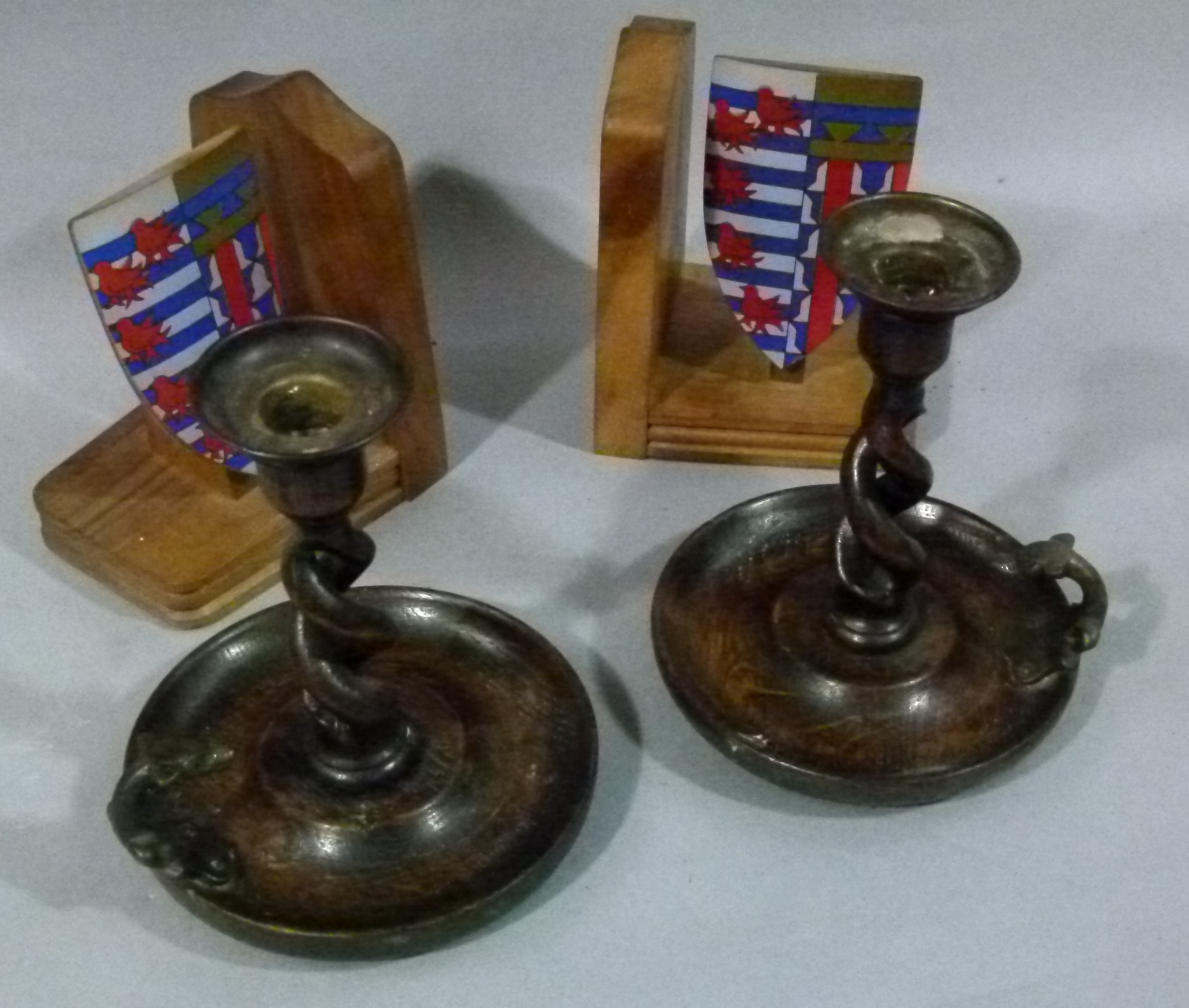 A pair of oak open barley twist candlesticks with dragon head handle; together with a pair of Ternex