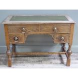 An oak desk, the rectangular top with inset gilt tooled green leather writing surface, above two