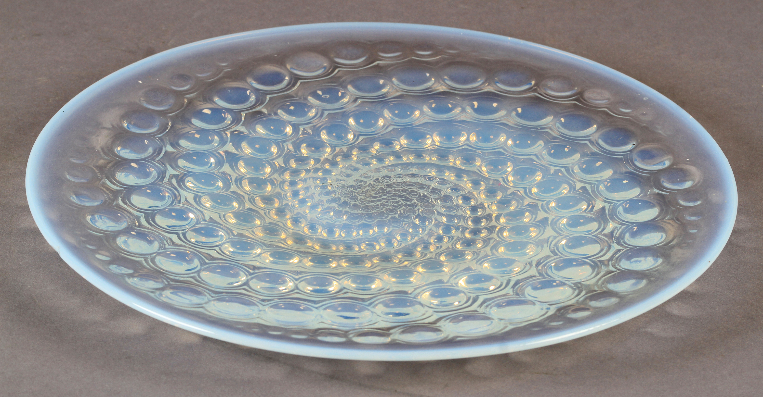 A Lalique opalescent glass plate of Volutes pattern, stencilled mark R LALIQUE, FRANCE, mark to