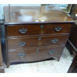 A mahogany chest of three long drawers with brass swing handles and pierced back plates and