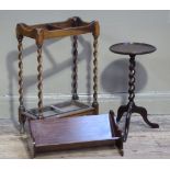 A reproduction mahogany book trough, 52cm wide; together with an umbrella stand with barley turned