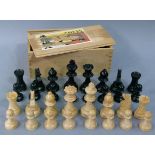 A Staunton type treen chess set in a wooden box with sliding lid