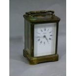 A brass cased carriage clock white enamel face with Roman and Arabic numerals inscribed Angelus,