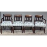 A set of four George IV mahogany dining chairs with reeded frames, the concave oversailing