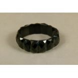 A Victorian jet bracelet of elasticated domed and faceted rectangular links, approximate width 20mm,