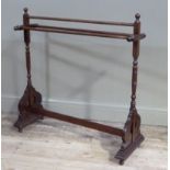 A late Victorian mahogany towel rail of conventional form, on turned posts with flattened pierced