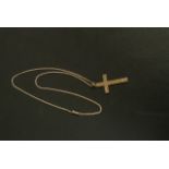 A late Victorian 9ct rose gold cross foliate engraved hung on a contemporary curb link chain with