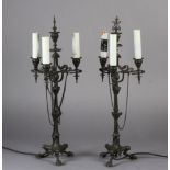 A pair of Napoleon III bronze table lamps, each having three lights on scrolled arms, on a fluted