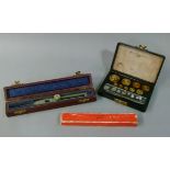 A box of weights from 50gm to 10mg in Bakelite case and various drawing instruments including a