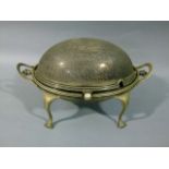 A silver plated oval revolving breakfast dish with revolving cover on scrolling legs, 34cm wide