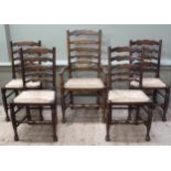 A set of five reproduction oak ladderback dining chairs, rush seats on turned legs joined by