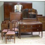 An Edwardian mahogany three piece bedroom suite comprising three door bow fronted wardrobe with