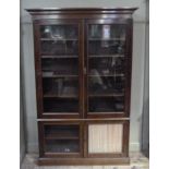 A 19th century mahogany and glazed bookcase having a moulded cornice above two large glazed doors