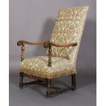 A Flemish walnut armchair, late 17th century, the later upholstered back and seat with scrolled arms