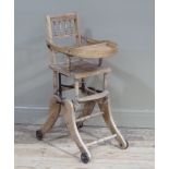 A Victorian ash child's chair with bobbin turned back, fold down tray on ratchet adjustable legs,