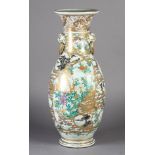 A Japanese vase c.1900 of baluster form painted with flowers, birds and pavilions in shaped