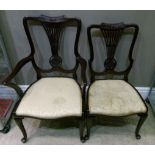 An Edwardian mahogany open arm chair and single chair, each having a carved top rail fanned