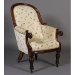 An early Victorian mahogany armchair having an encircling frame, foliate carved and scrolled arm