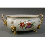 A large two handled garden porcelain bowl on lion mask and paw feet, polychrome enamelled with
