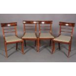 A SET OF FOUR REGENCY MAHOGANY SABRE LEG DINING CHAIRS with figured concave cresting rails and