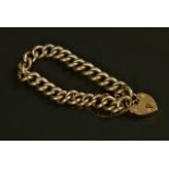 An Edward VII hollow curb link bracelet in 9ct rose gold fastened with a padlock fastener,