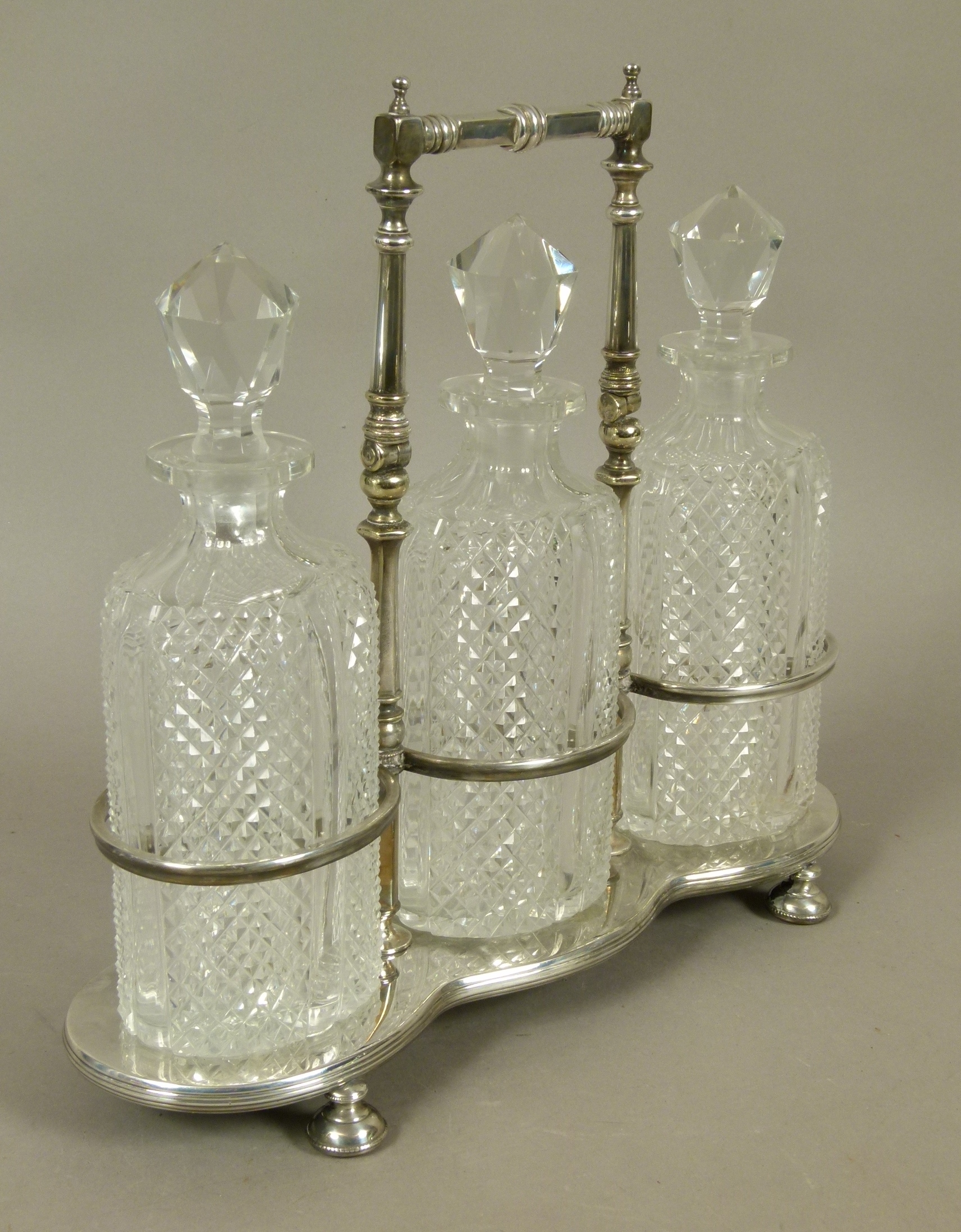 A late Victorian/Edwardian VII silver plated triple decanter stand and three diamond cut glass - Image 2 of 2