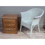 A reproduction pine three drawer chest; together with a Lloyd Loom style pale green wicker armchair