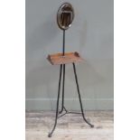 A late Victorian iron and brass shaving stand, the circular bevelled plate within a brass bezel